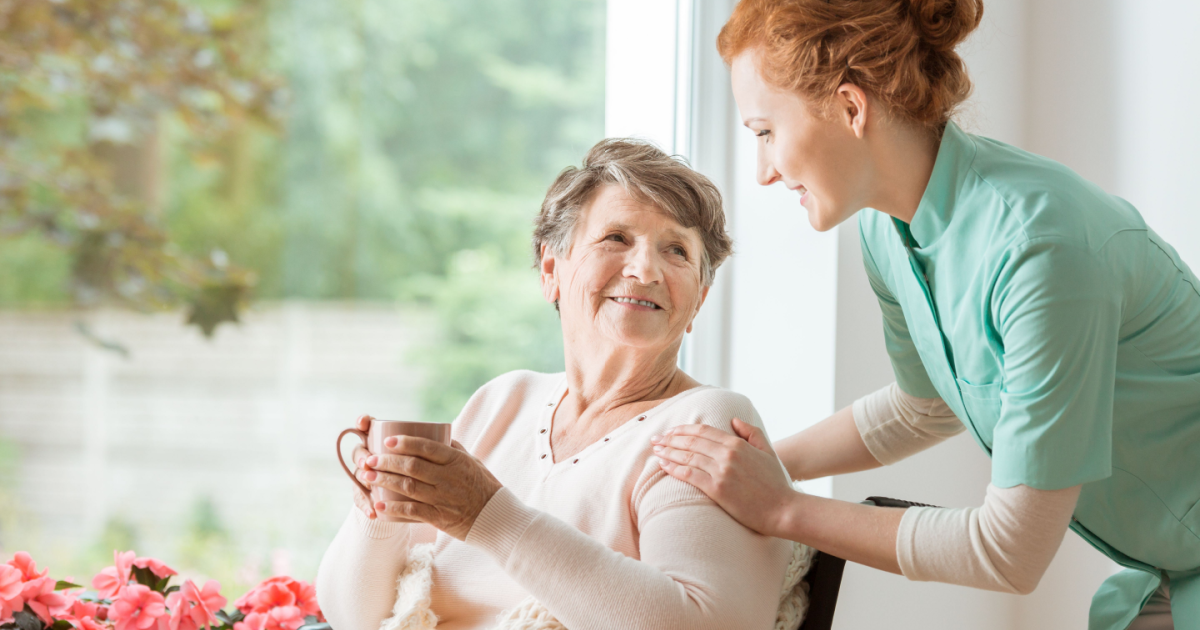 As an example of compassionate home care, a caregiver shows kindness as she cares for and checks on a senior client.